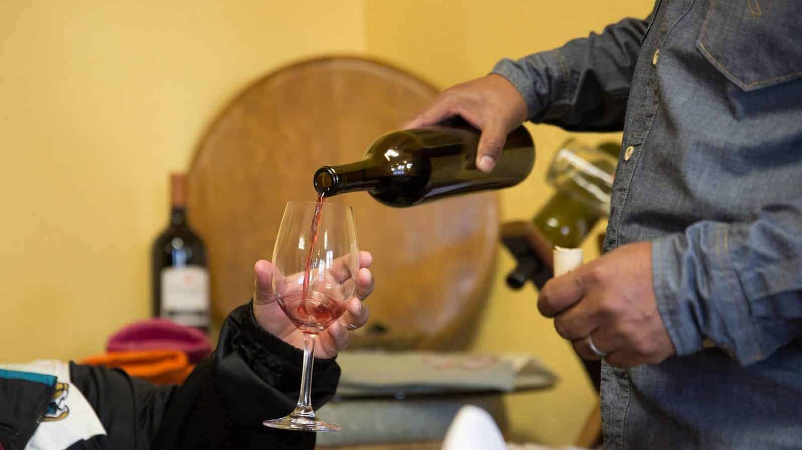 Vintner Pouring Wine Into A Guest's Glass